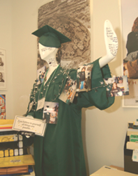 A mannequin dressed in a West High Trojan-green cap and gown