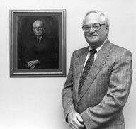 Leonard Feldt stands next to a portrait of his mentor, E.F. Lindquist